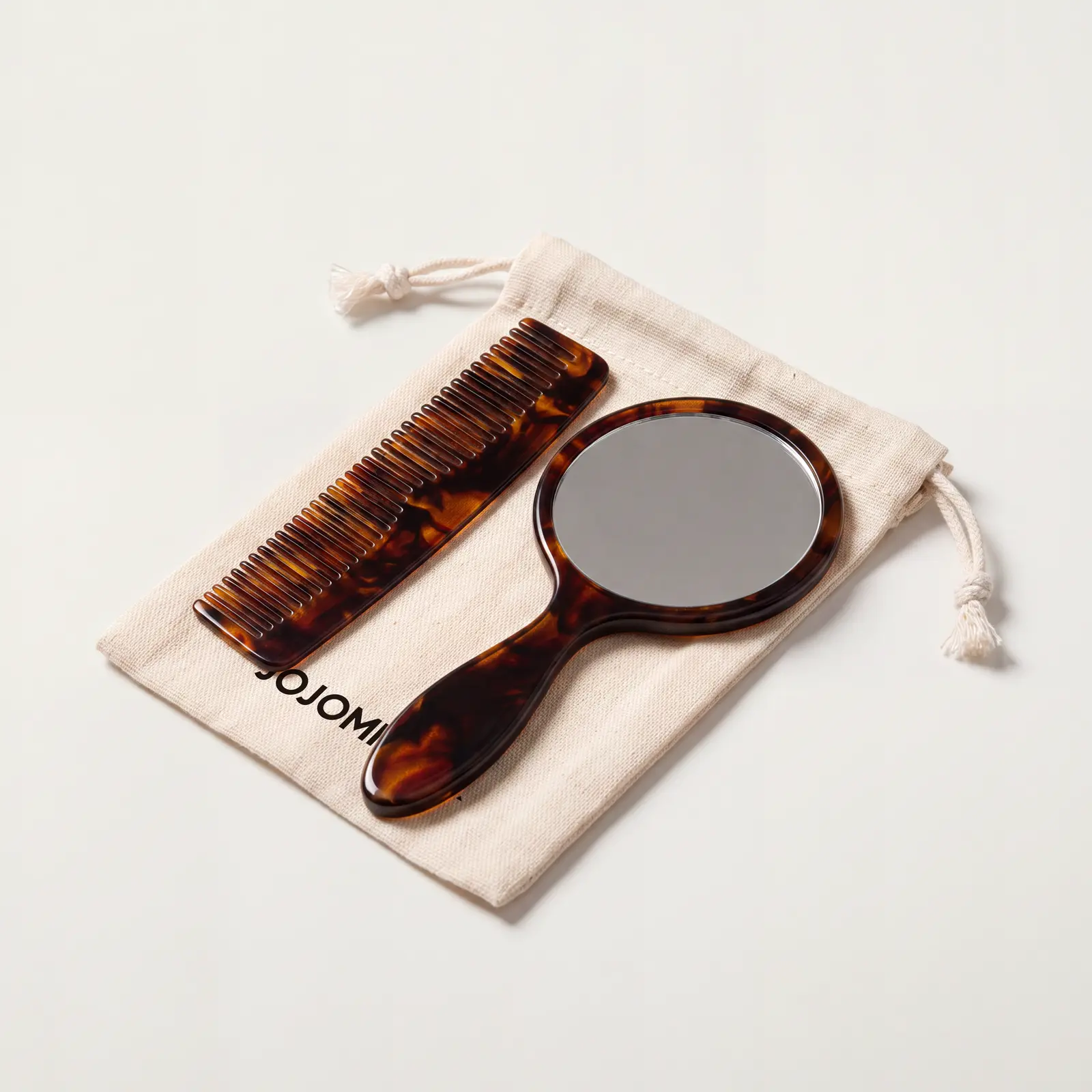 Tortoiseshell-look hand mirror and comb with drawstring pouch