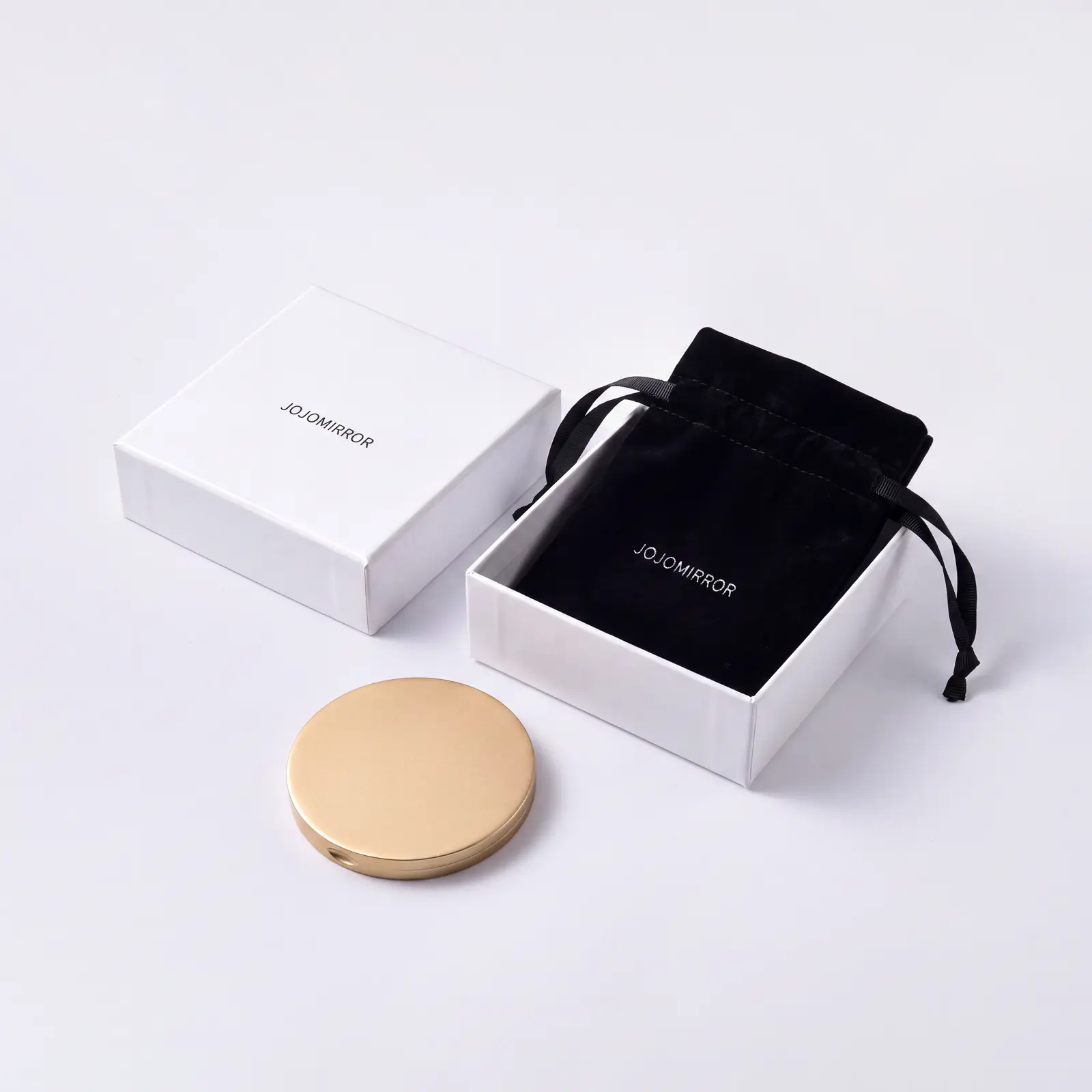 Round compact mirror with black drawstring pouch and white gift box