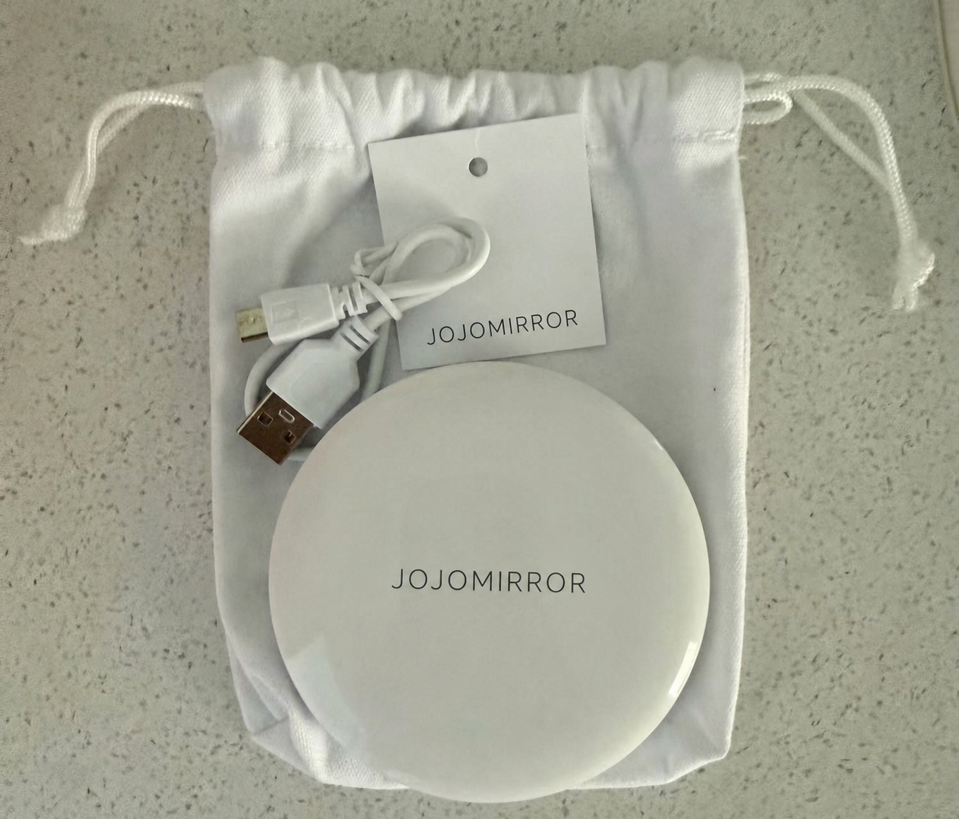 Closed white LED compact mirror, USB cable, hangtag and drawstring pouch for the Iceland order